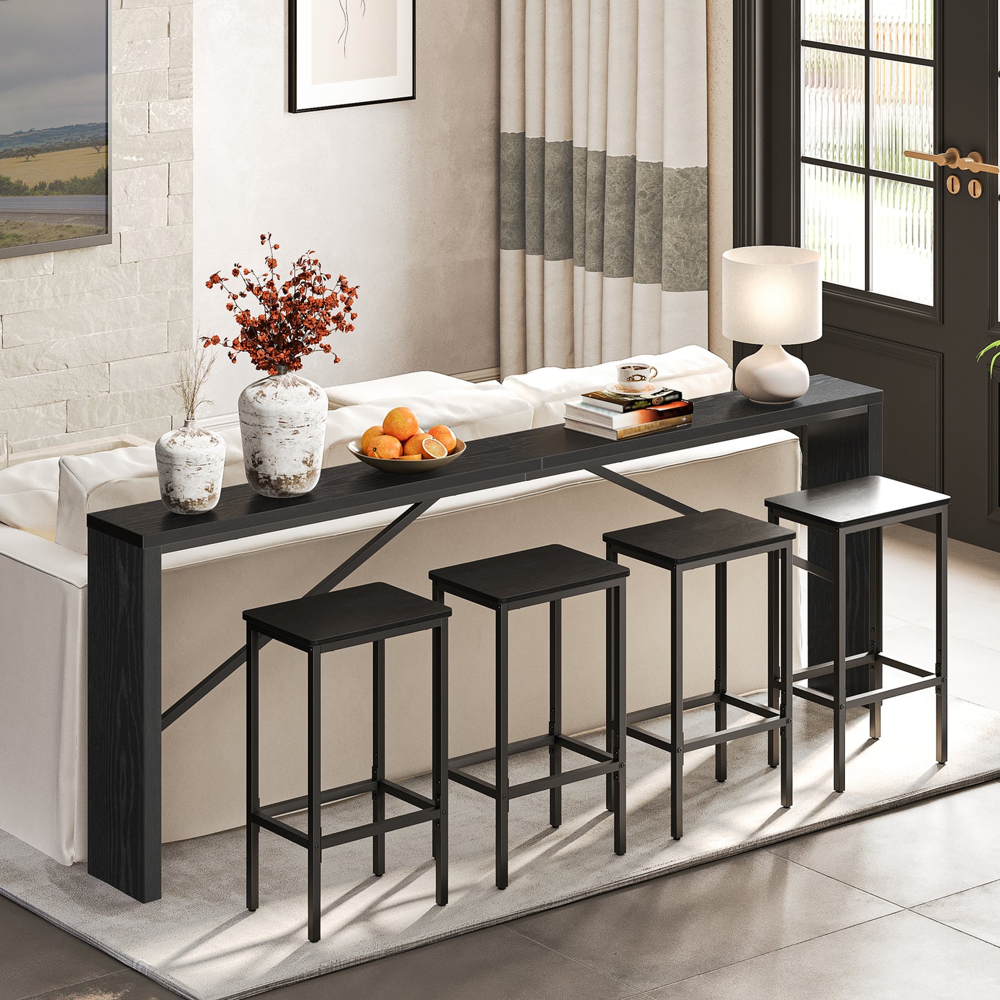 slim black console table behind the couch with 4 stools