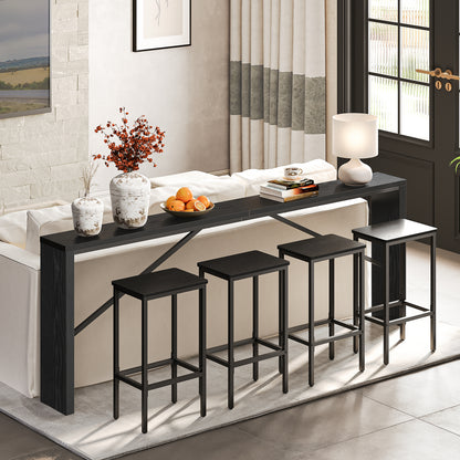 slim black console table behind the couch with 4 stools