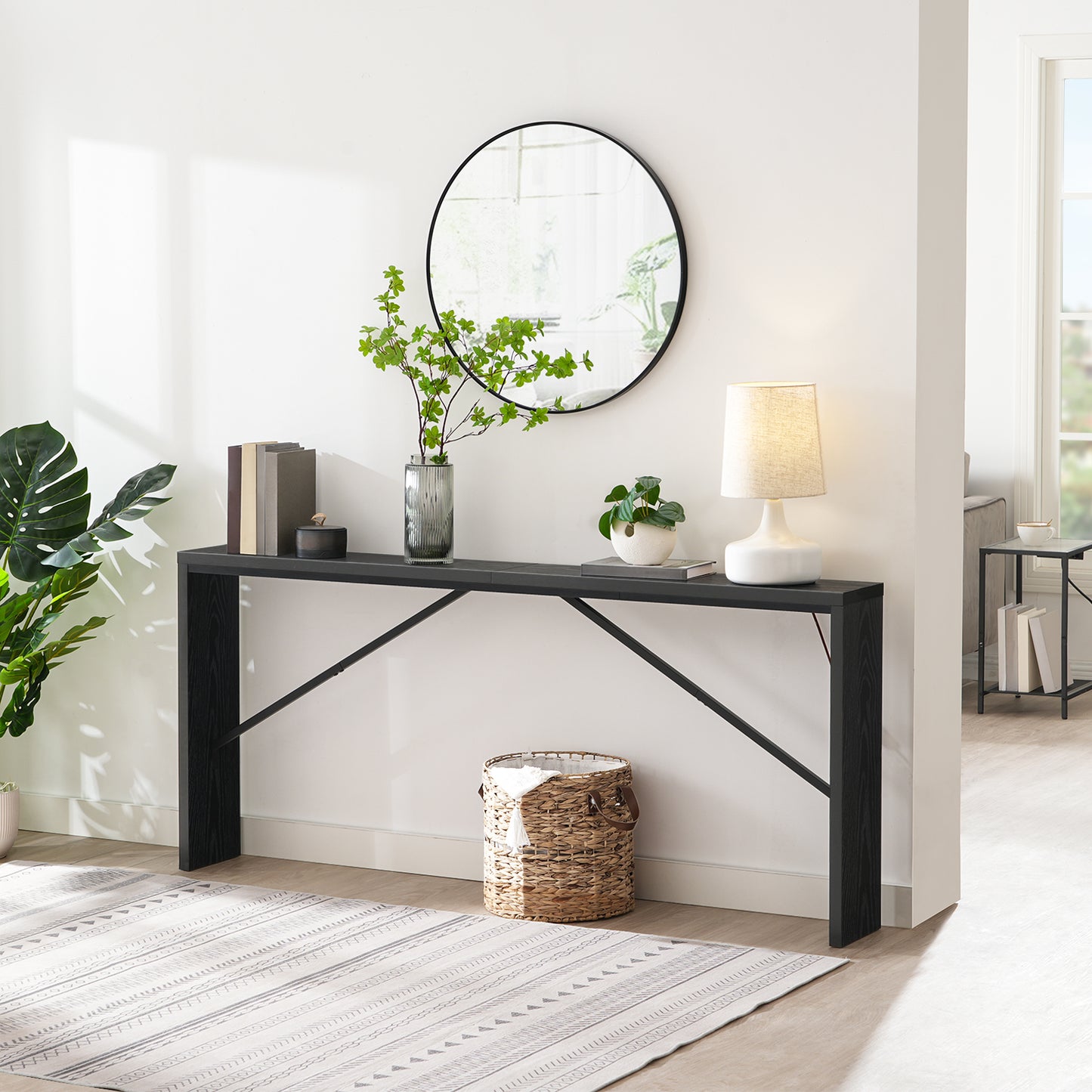 decorative black entryway table with vase and books