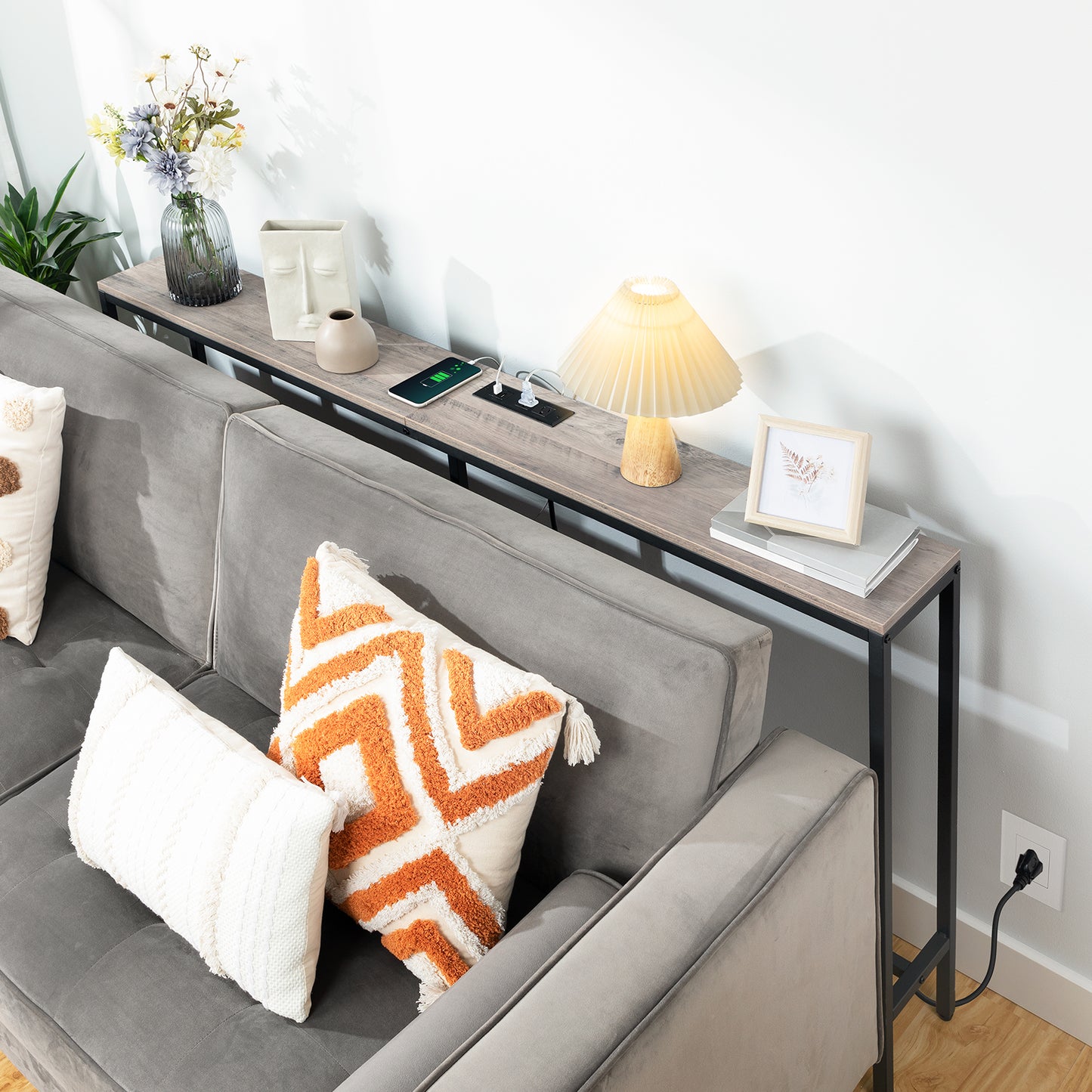 slim wooden console table behind couch